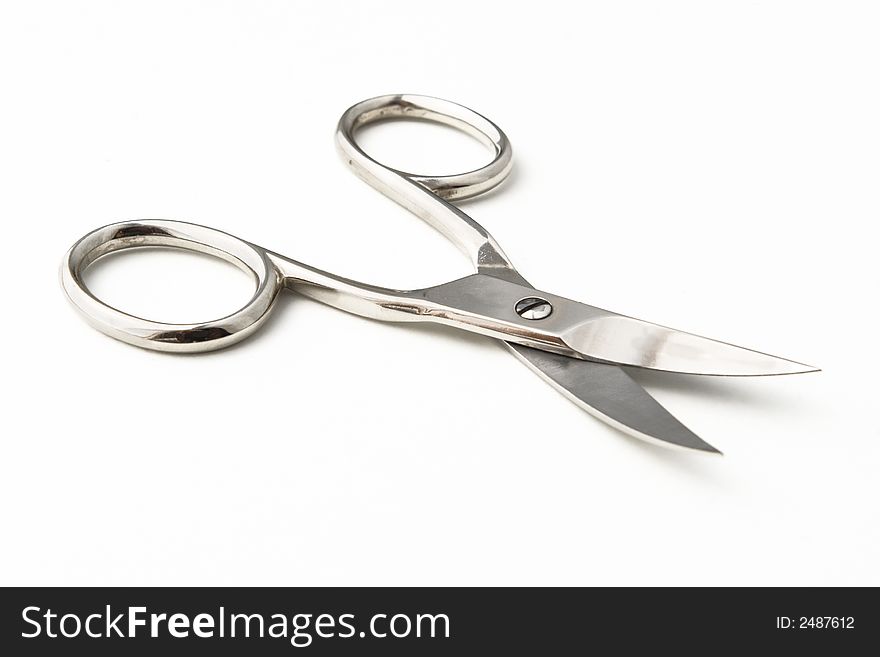 Half opened cosmetic scissors on white. Half opened cosmetic scissors on white