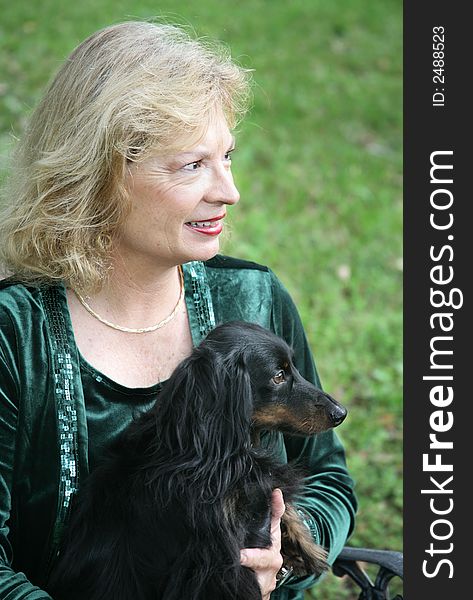 A portrait of a mature woman and her dachshund in profile. A portrait of a mature woman and her dachshund in profile.