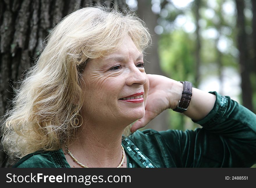 A pretty, mature blond woman in the park. A pretty, mature blond woman in the park.