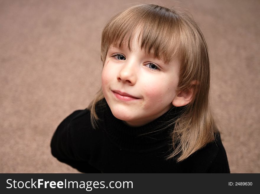 The girl smiles on the carpet background