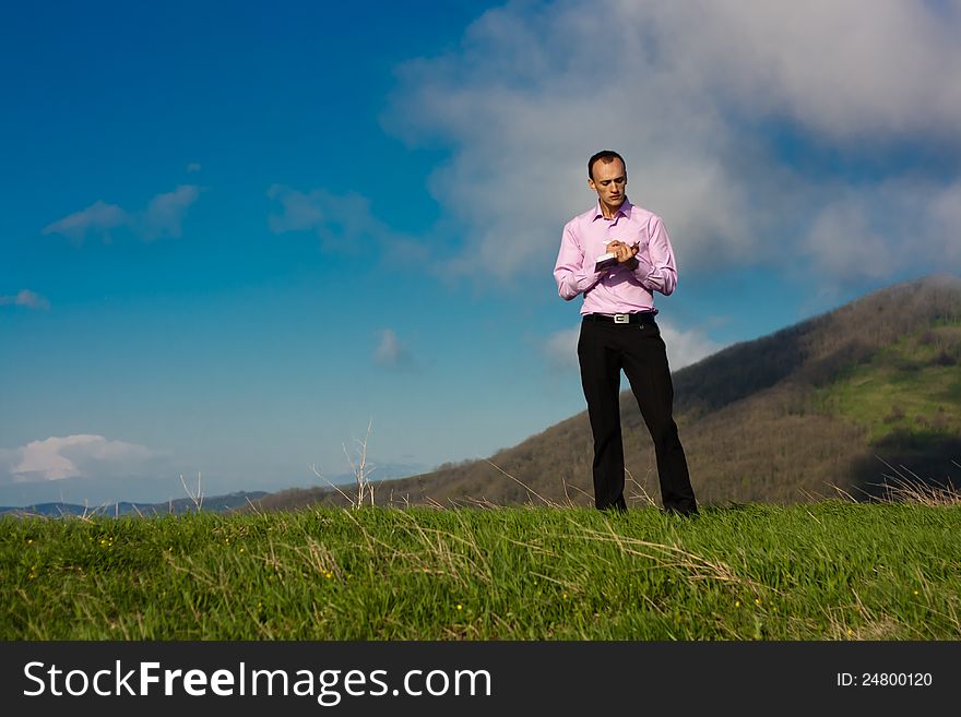 Man With Notepad On Mountain