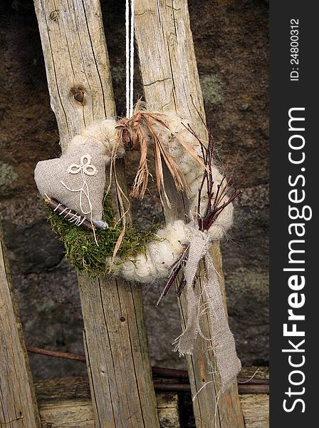 My handmade wreath on the door with natural materials: twigs, sticks, moss, linen, sheep wool