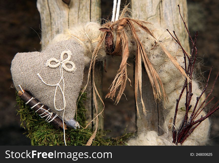 My handmade wreath on the door with natural materials: twigs, sticks, moss, linen, sheep wool