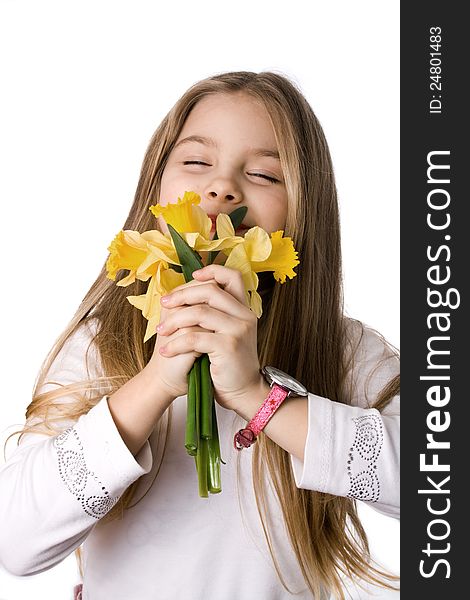 Beautiful little girl with a bouquet of daffodils