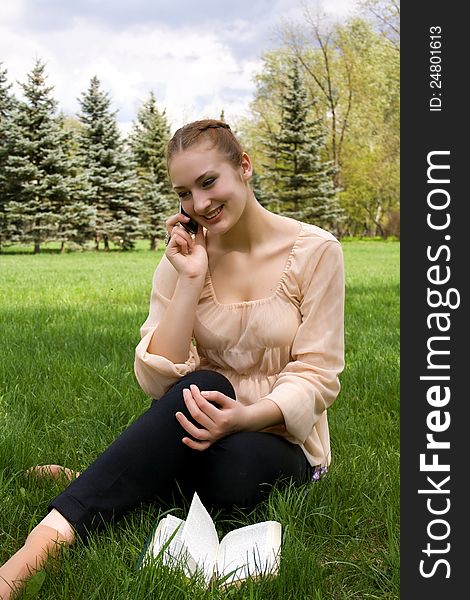 Woman relaxing in nature. Talking on the phone. Woman relaxing in nature. Talking on the phone