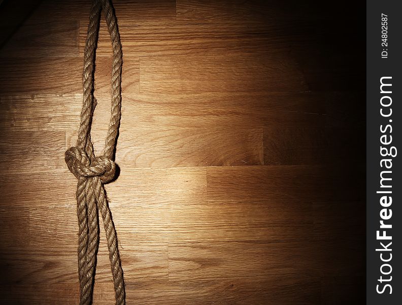 Old rope over wooden background. Old rope over wooden background