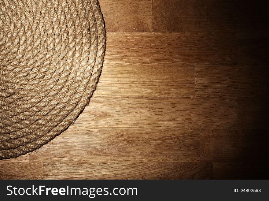 Old rope over wooden background. Old rope over wooden background