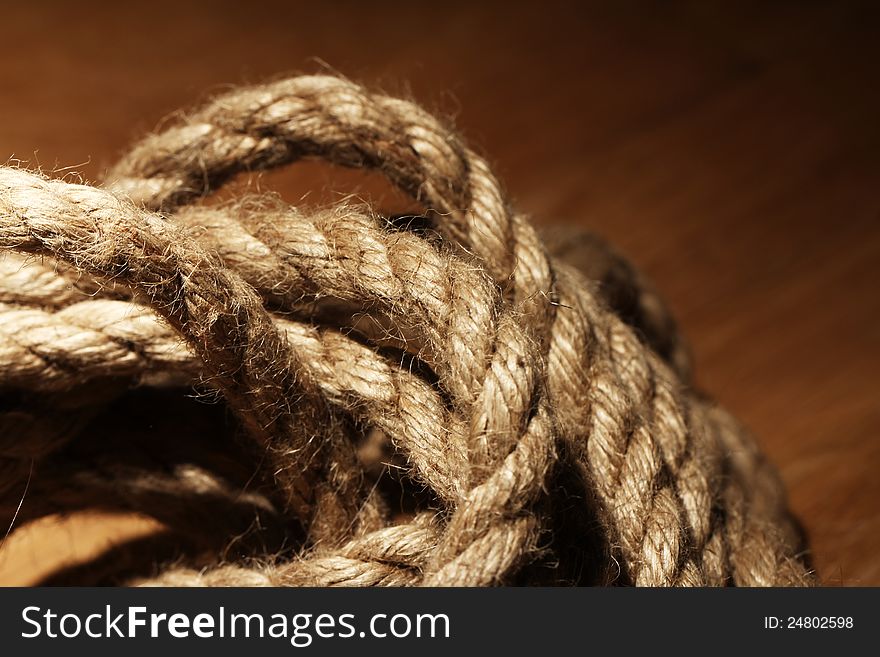 Old rope over wooden background. Old rope over wooden background