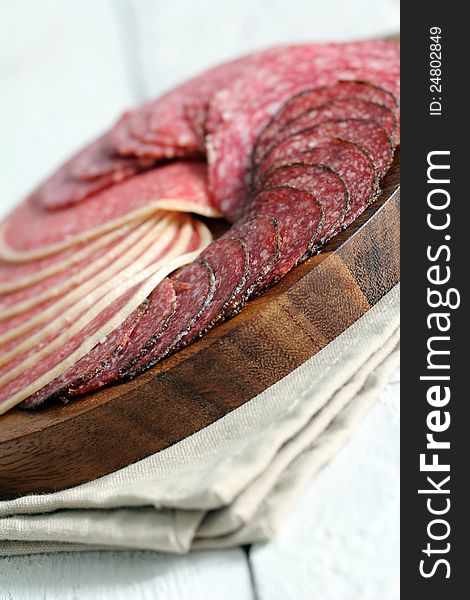 Fresh and delicious salami over wooden surface