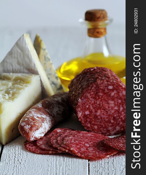 Salami and cheese on wooden table