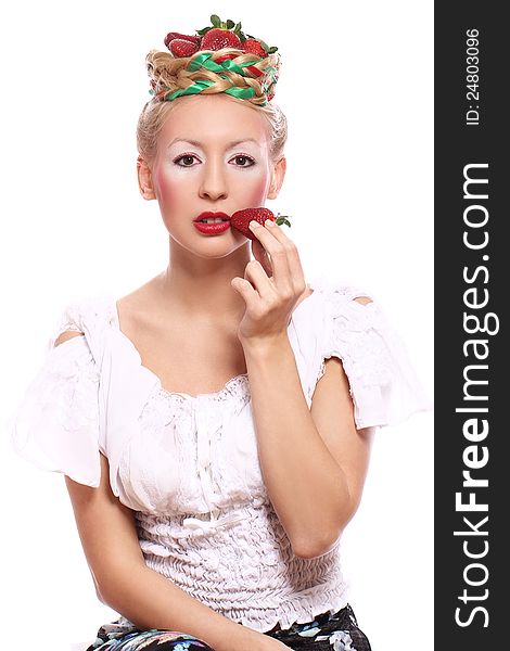 Woman with strawberry in her hairstyle over white background