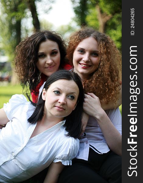 Portrait of three girls posing in the park summer