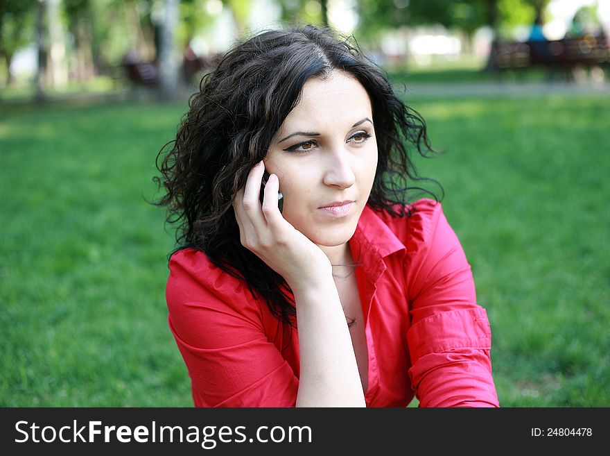 Portrait of a girl in a red shirt with the phone