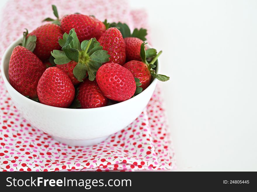Strawberries in a white bowl with space for text