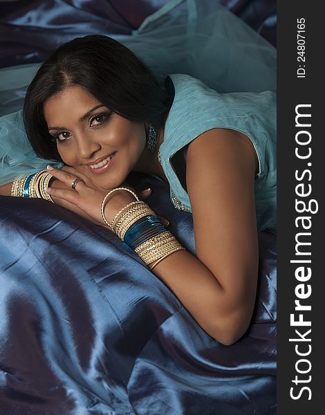 Indian Beauty In Blue Reclining