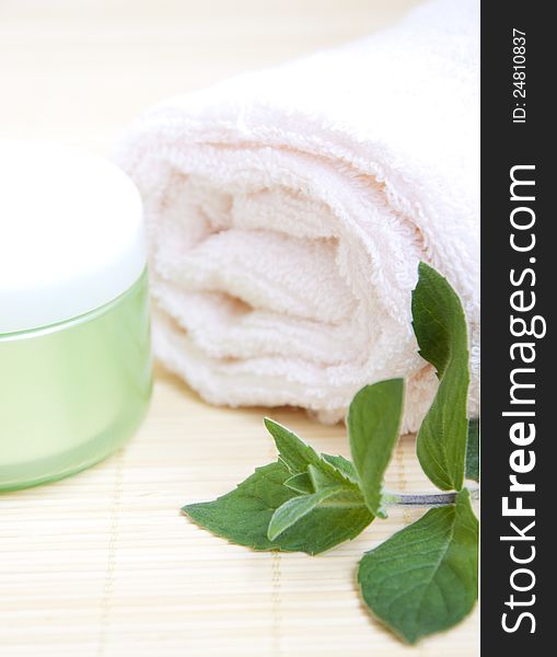 Cosmetic moisturizing cream with mint and towel. Cosmetic moisturizing cream with mint and towel