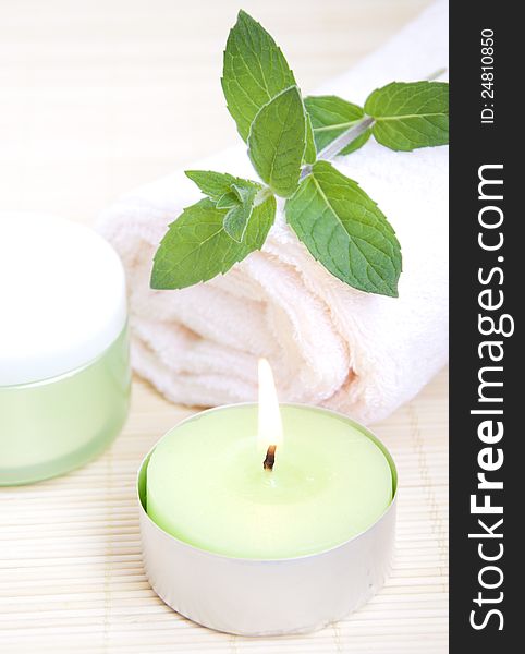 Cosmetic moisturizing cream with mint, candle and towel. Cosmetic moisturizing cream with mint, candle and towel