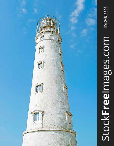 White Lighthouse in the center of the blue sky