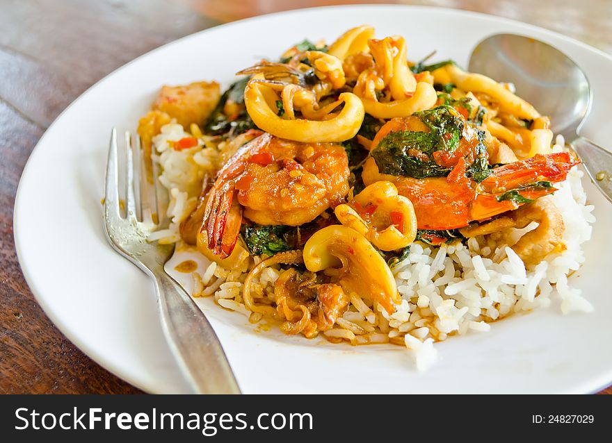 Fried basil leave with squid and shrimp on white dish