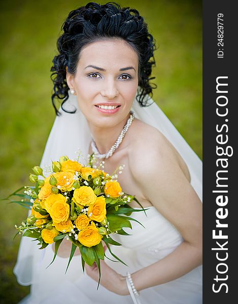 Portrait of beautiful young bride in garden