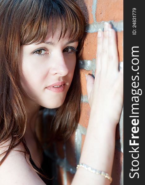 Close-up portrait of young redhead against the wall. Close-up portrait of young redhead against the wall