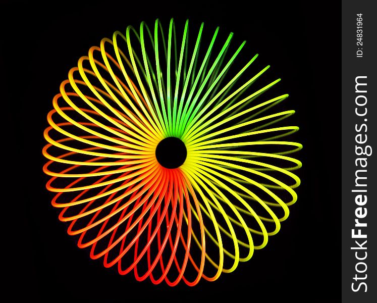 Slinky which rolling up in endless spiral. Slinky which rolling up in endless spiral