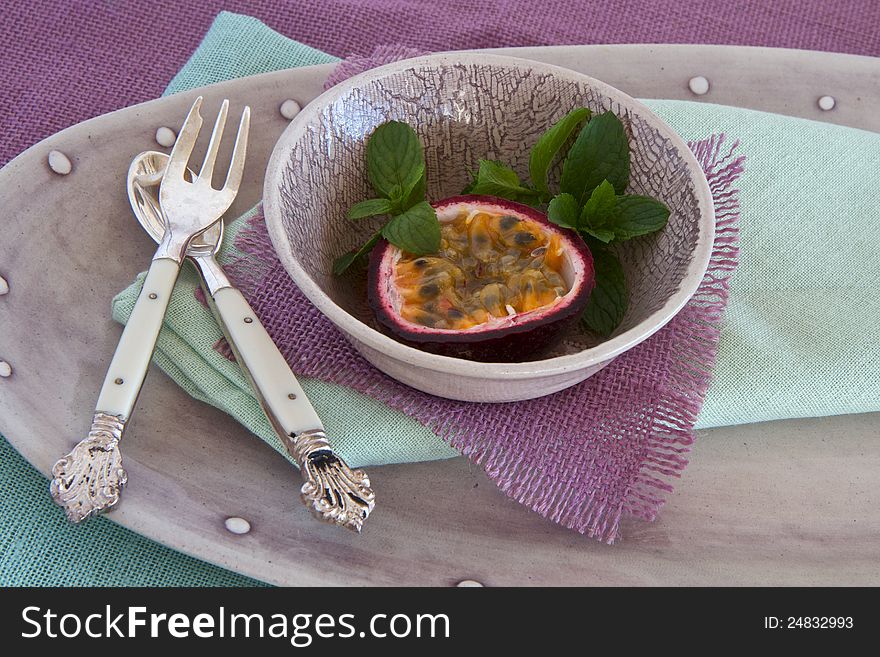 Granadilla with mint and vintage spoon and fork. Granadilla with mint and vintage spoon and fork