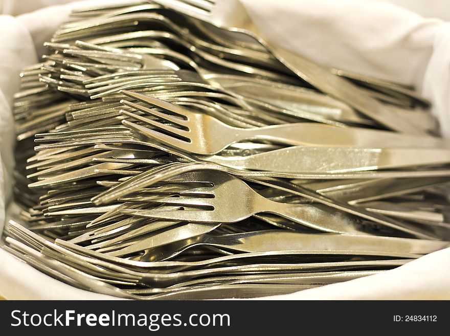 Pile of forks on white cloth