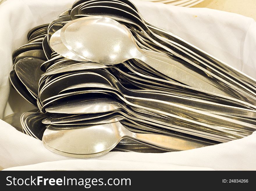 Pile of spoons on white cloth