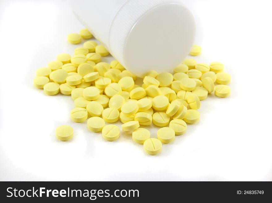 Medicine pills with and bottle on white background