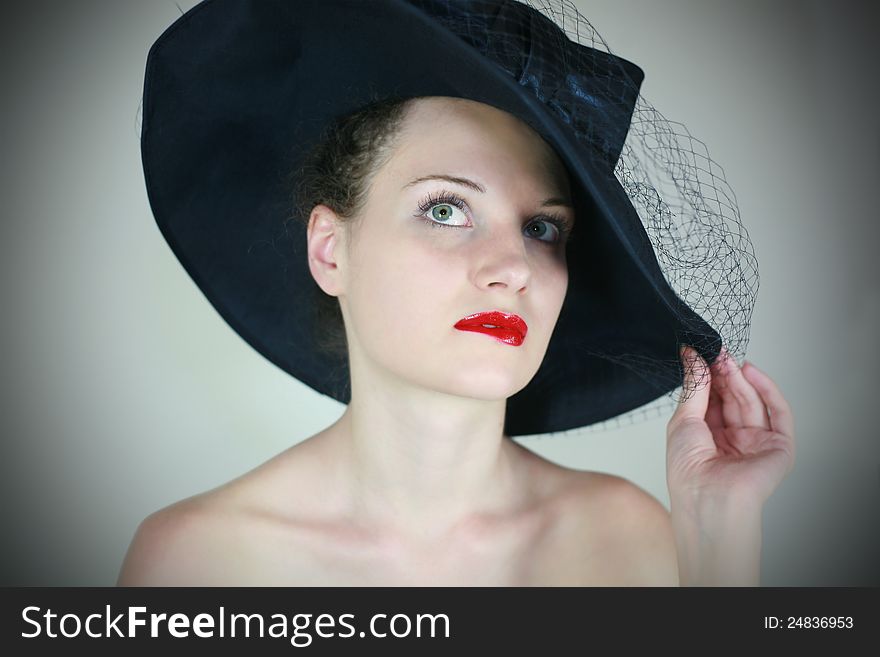 Portrait of a cute girl in retro hat with red lips