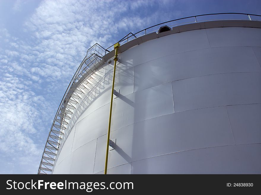 Old industrial oil tank closeup and blue sky