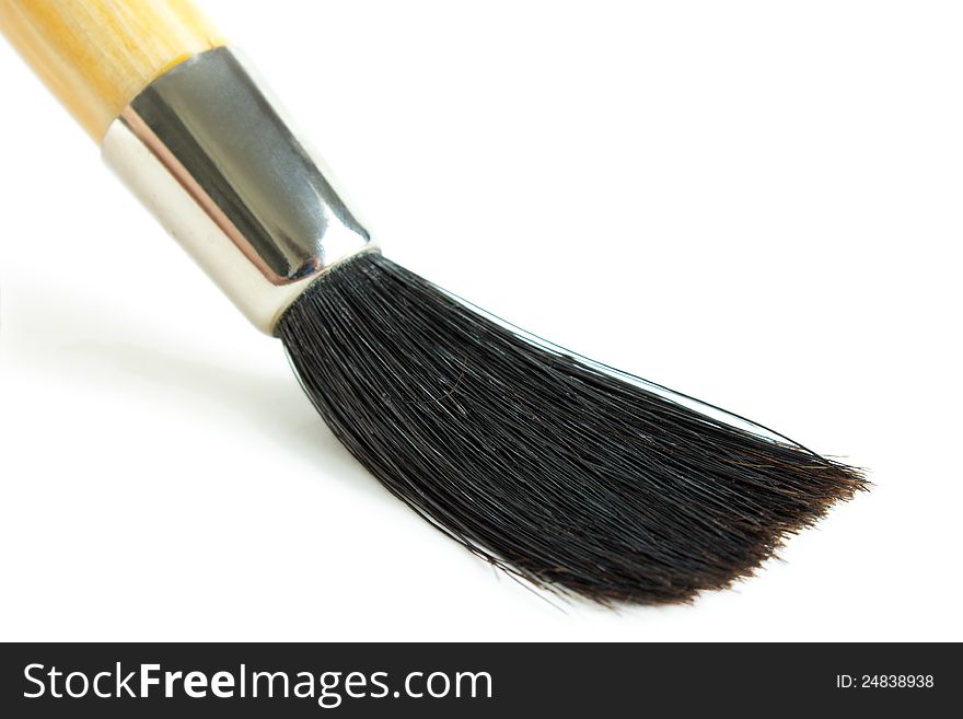 Artwork paint brush closeup, white background with shadow