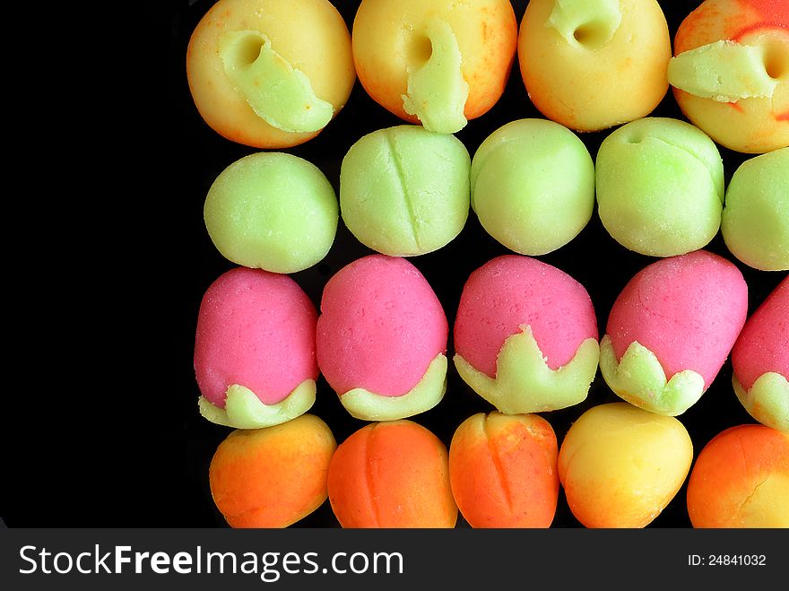 Colorful small cookies isolated on black