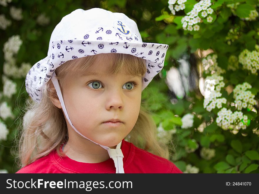 Little serious girl in a white cap. Little serious girl in a white cap