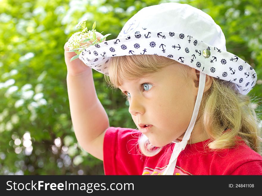 Little serious girl in a white cap. Little serious girl in a white cap