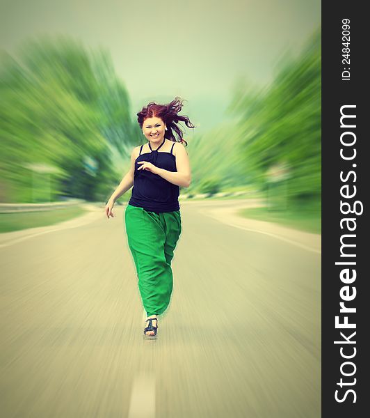 Happy, cheerful girl running down the road. Happy, cheerful girl running down the road