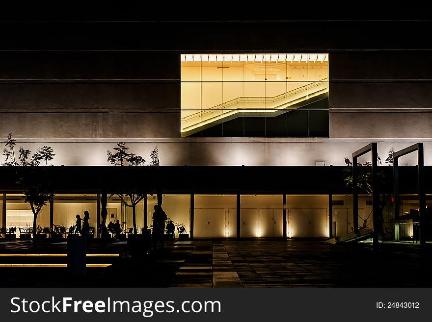 Building illuminated at night with a stairway in the windows