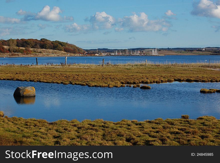 The blue bay at Kalø, cross-sected by a patch of grassy land. The blue bay at Kalø, cross-sected by a patch of grassy land