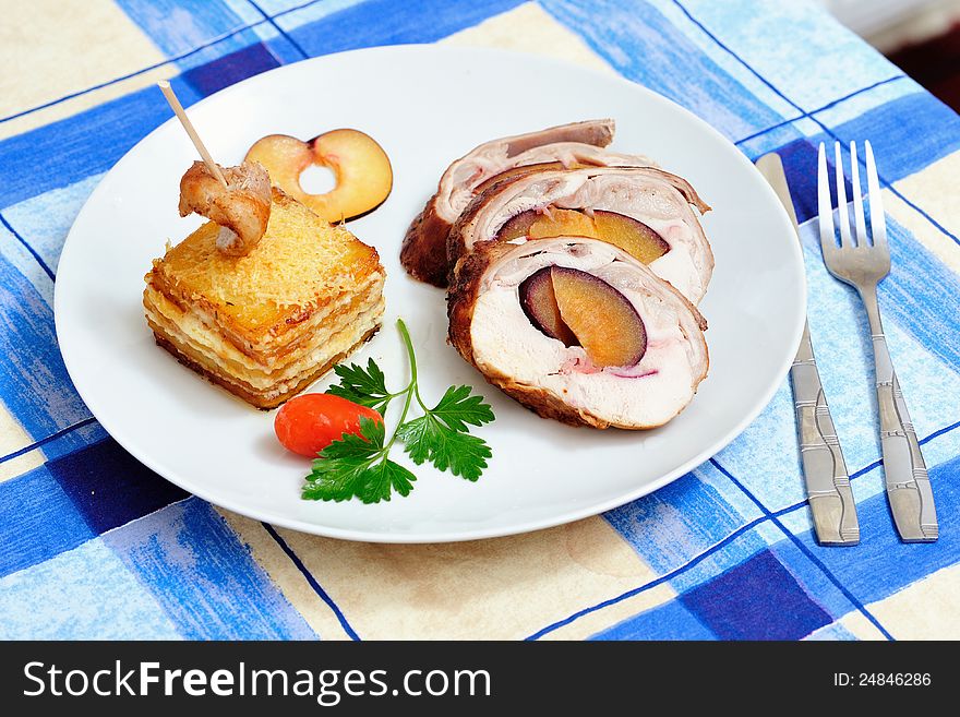 Stuffed rabbit filled with plums, fried in butter and then roasted in the oven with potatoes and cheese garnish. Stuffed rabbit filled with plums, fried in butter and then roasted in the oven with potatoes and cheese garnish