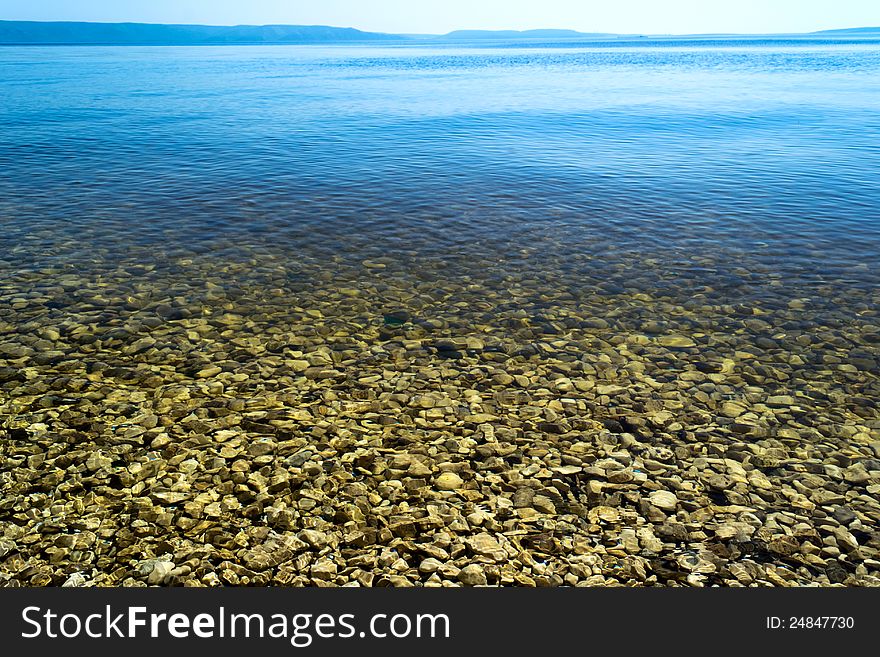 Coastline. The surface of the water with reflections. Coastline. The surface of the water with reflections