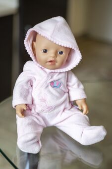 St. Petersburg, Russia - 20.08.2021: A Toy For A Girl Doll Little Baby Born In A Pink Jumpsuit With A Hood Royalty Free Stock Photography