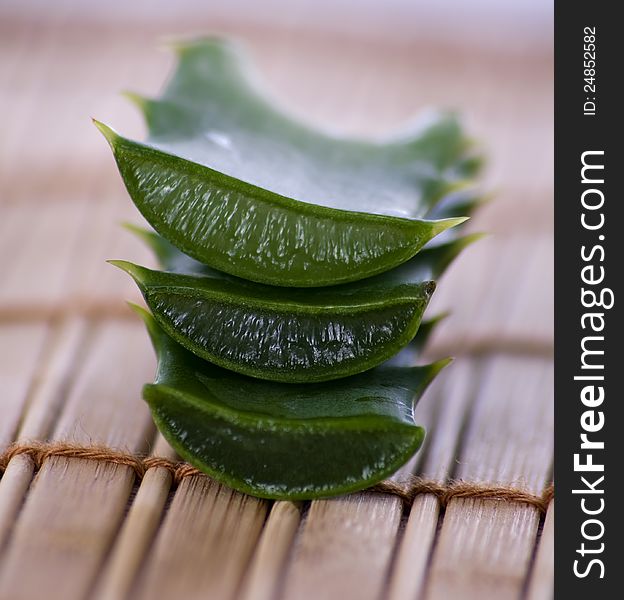 Stack of freshly sliced Aloe Vera on a wooden background