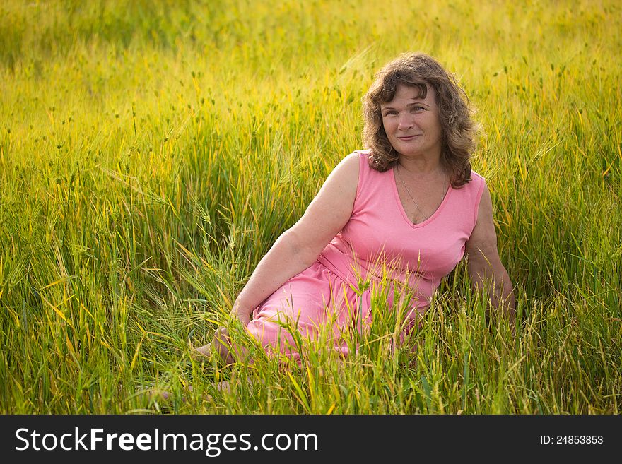 Beautiful senior woman in the wheat field. Beautiful senior woman in the wheat field