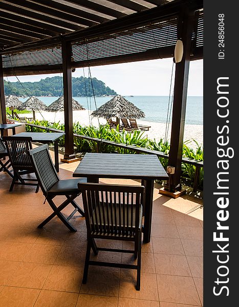Tables and chairs in a restaurant with beach view. Tables and chairs in a restaurant with beach view