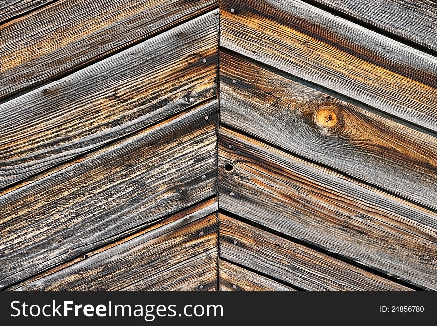 Old weather-beaten boards, element of the sheeting of the lodge