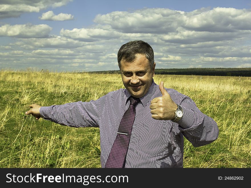 Portrait of a businessman in a shirt and tie, with a raised finger up, outdoors