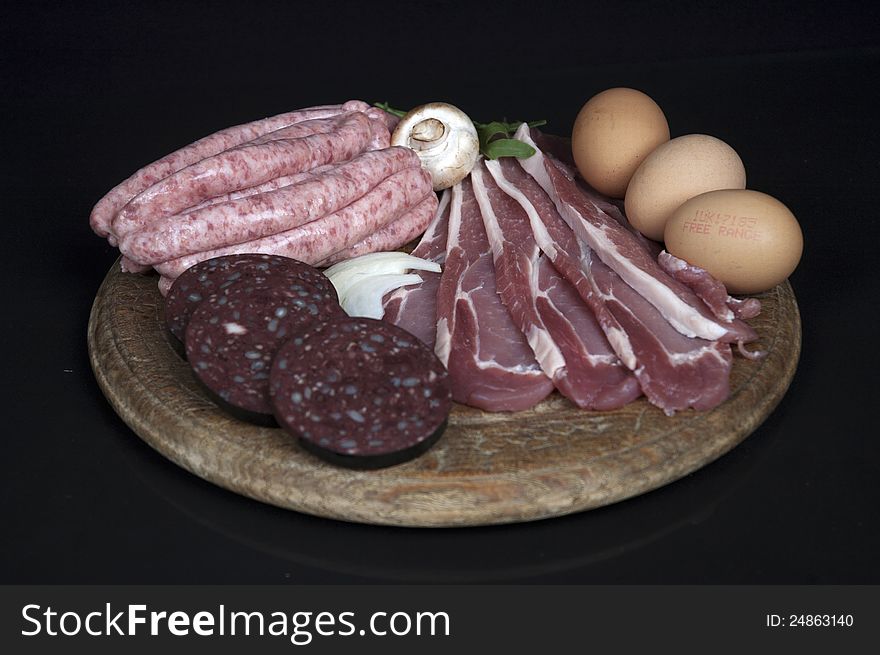 Breakfast meats with egg, bacon and sausage