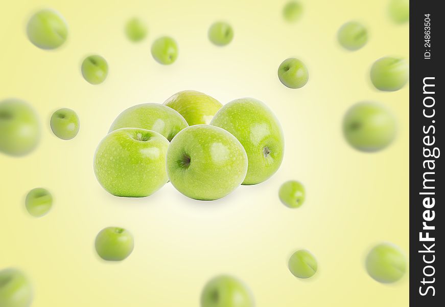 Group of green apples on a yellow background