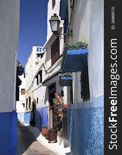 Narrow streets with brightly painted blue and white walls contrast against the blue sky while keeping cool under the warm middle- eastern sun. Narrow streets with brightly painted blue and white walls contrast against the blue sky while keeping cool under the warm middle- eastern sun.